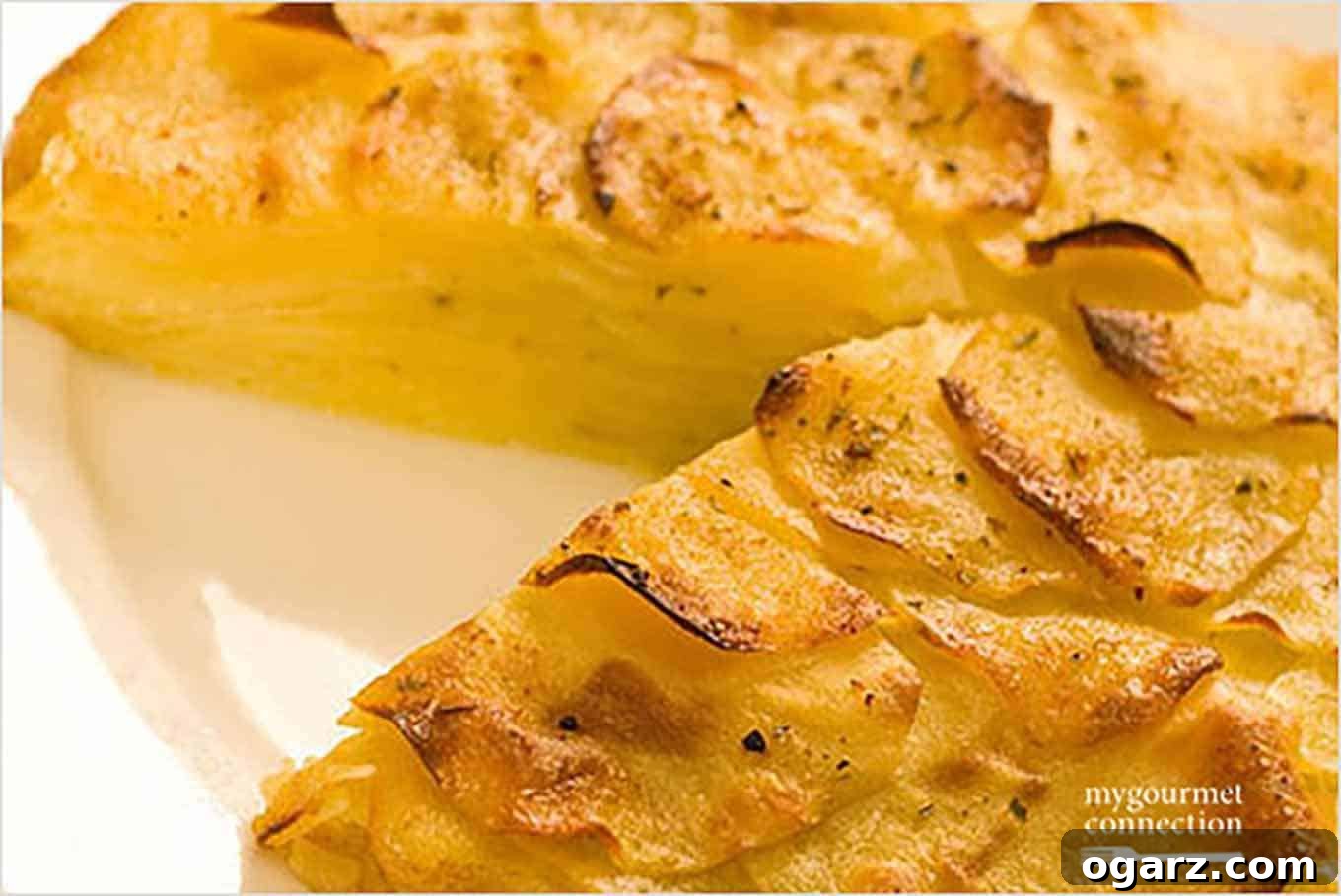 Crispy Golden Potato Galette 2 Golden brown Oven-Roasted Potato Galette, sliced and ready to serve on a white plate