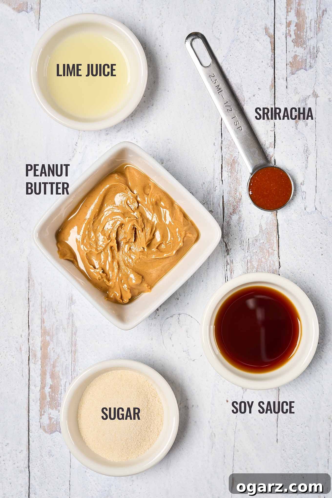 Spicy Thai Chicken Flatbread 4 A labeled, overhead view of the ingredients for a delicious peanut sauce including, sugar, soy sauce, fresh lime juice, creamy peanut butter, and sriracha hot sauce.