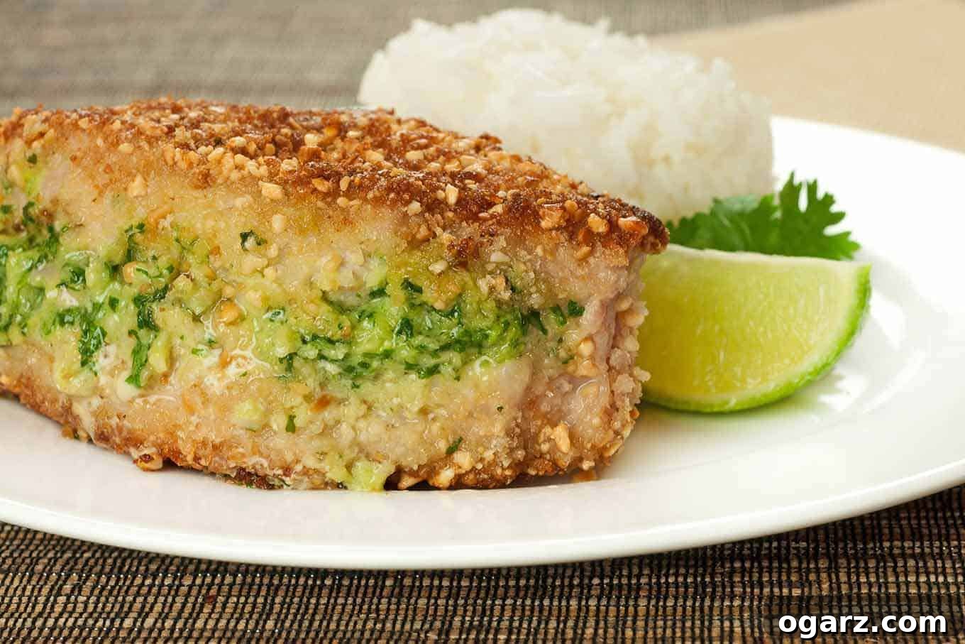 Crunchy Thai Peanut Pork Chops 2 Crispy Thai-Style Peanut and Panko-Crusted Pork Chops served with jasmine rice and snap peas