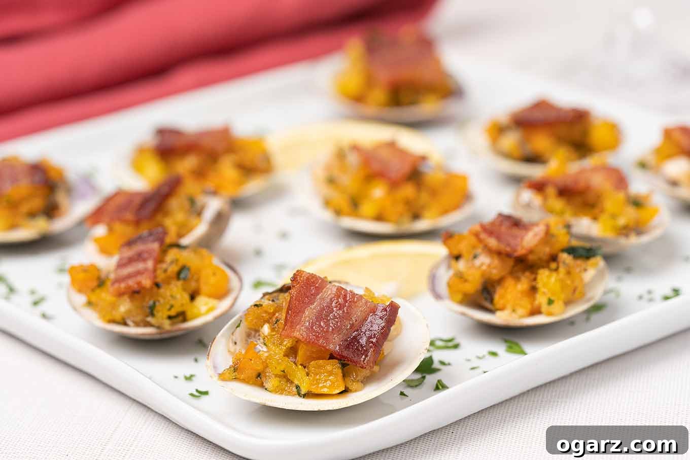Classic New England Clams Casino 4 Exquisite New England Clams Casino, beautifully arranged on a serving plate, adorned with golden-crisp bacon, fresh parsley, and bright lemon wedges.