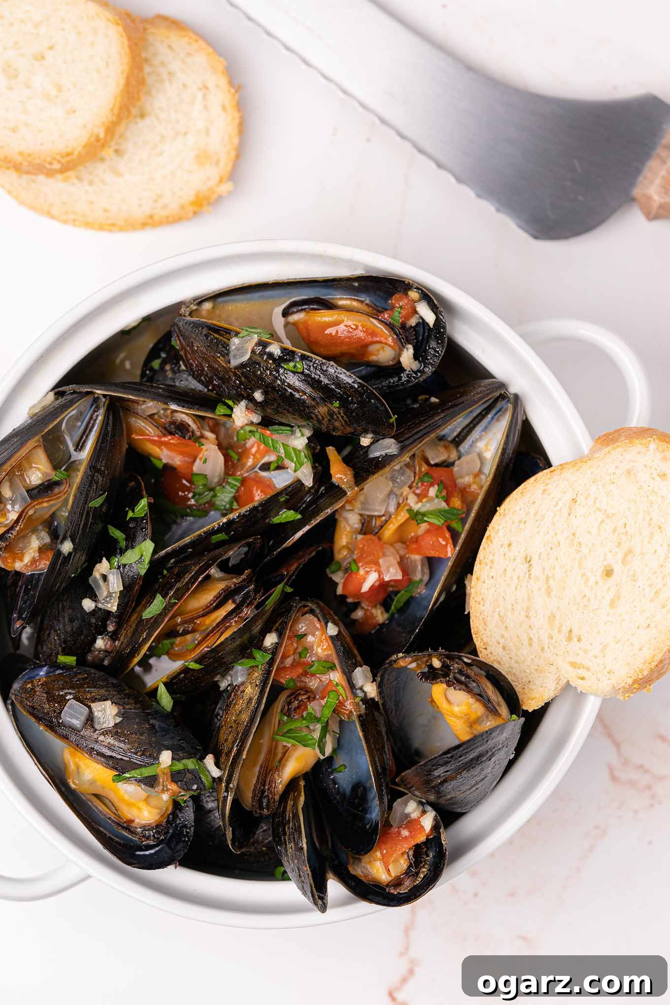Mussels Italia 2 Crock filled with steamed mussels topped with sautéed garlic, onion, diced tomatoes, and parsley,