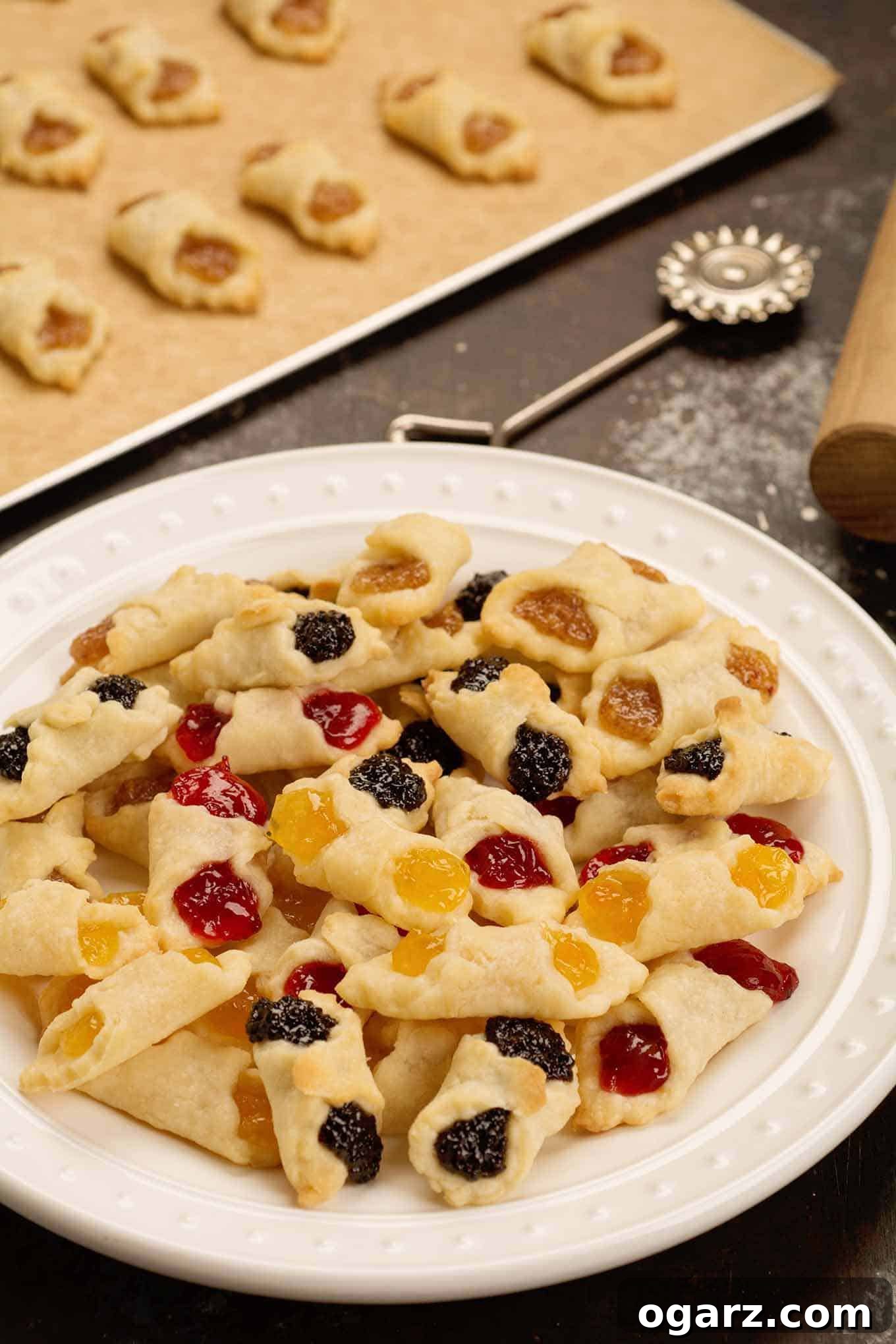 Our Family's Treasured Hungarian Kiffle Recipe 3 A serving plate piled with fresh baked Hungarian kiffles in assorted flavors of cherry, poppy, almond, and apricot, ready for serving.