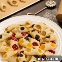 Our Family's Treasured Hungarian Kiffle Recipe 5 A serving plate piled with fresh baked Hungarian kiffles in assorted flavors of cherry, poppy, almond, and apricot.