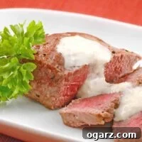 Close-up view of pan-seared steak medallions with creamy Gorgonzola-Horseradish sauce.