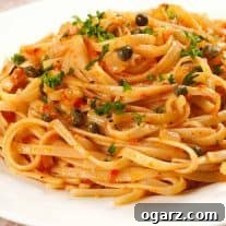 Close-up of Linguine with Roasted Red Pepper Sauce, showing the rich texture and fresh parsley garnish.