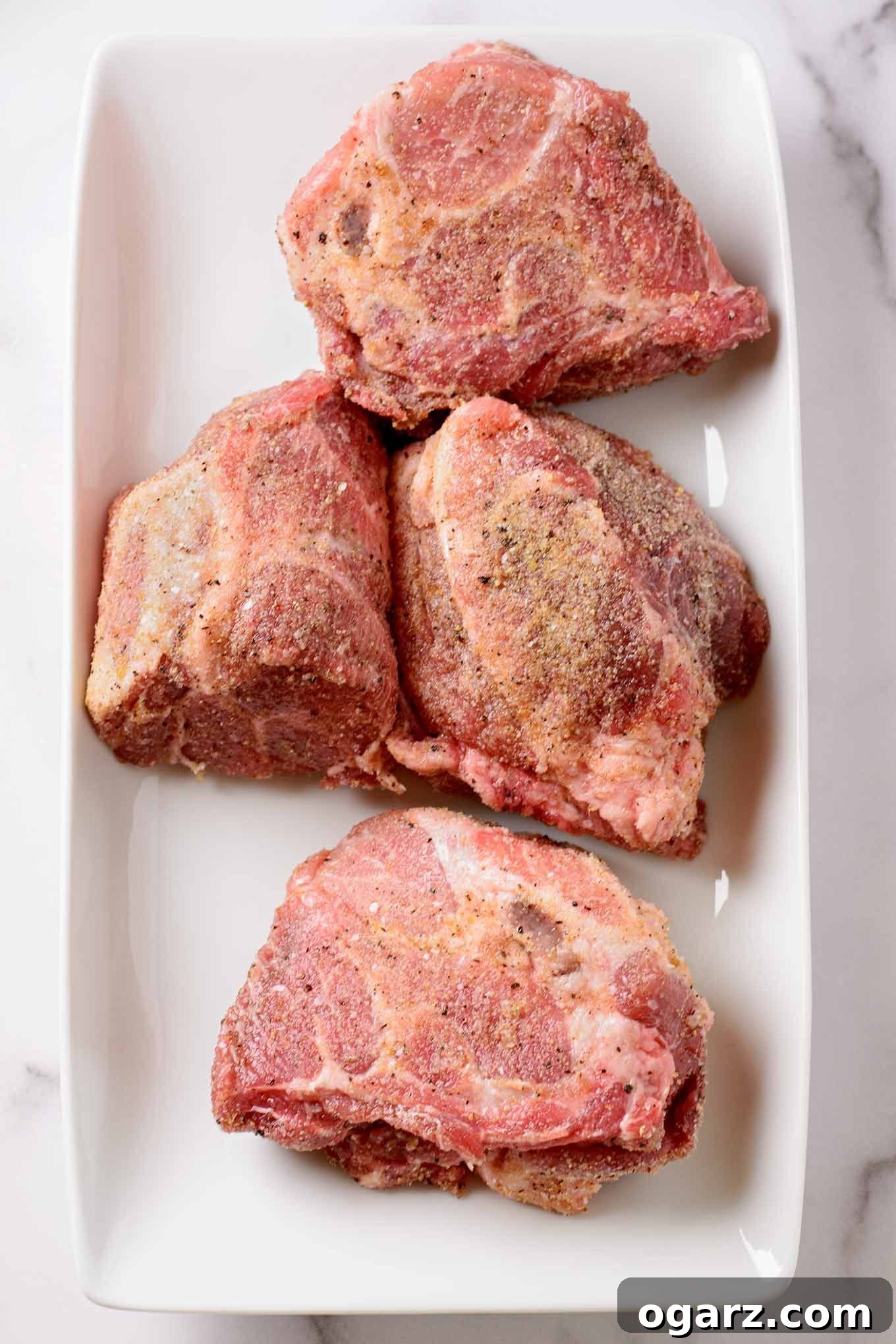 Perfectly Tender Oven-Roasted Pulled Pork 3 A Boston butt pork roast trimmed of excess fat, seasoned, and cut into quarters for faster, more even cooking.