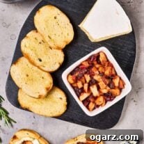 A cheese board with slices of baguette, a wedge of Brie cheese, and a dish of apple cranberry chutney, alongside two prepared cheese and chutney toasts.