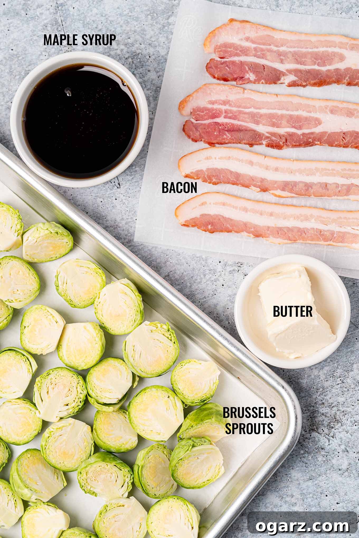 Caramelized Maple Brussels with Crispy Bacon 3 A labeled, overhead view of the ingredients for maple glazed Brussels sprouts including bacon, maple syrup, butter, and fresh Brussels sprouts.