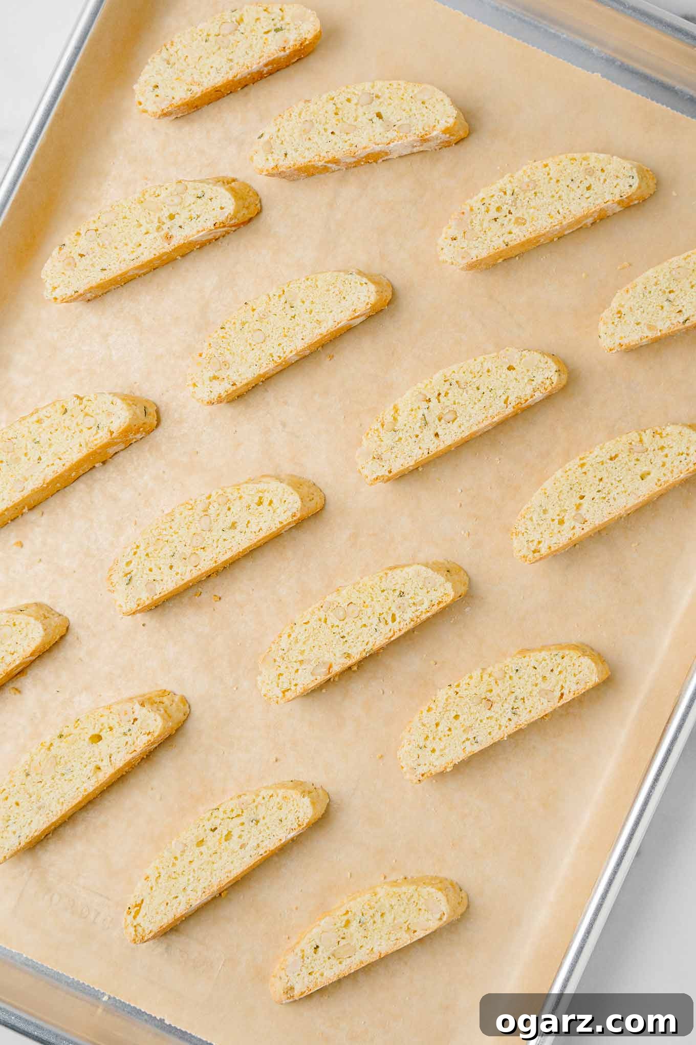 Golden Buttery Orange Biscotti 6 Golden brown American style biscotti (made with butter) on a parchment lined baking sheet after their second baking.