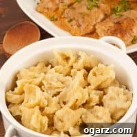 Hungarian noodle dumplings (nokedli) served in a white ceramic bowl, ready to be enjoyed.