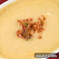 Cauliflower and Gouda Soup, a close-up of a bowl garnished with crispy prosciutto and rosemary