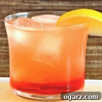 A refreshing Campari-Limoncello Spritzer, garnished with a lemon slice and ready to be enjoyed.