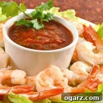 A close-up of Tequila-Lime Shrimp Cocktail with sauce and cilantro garnish.