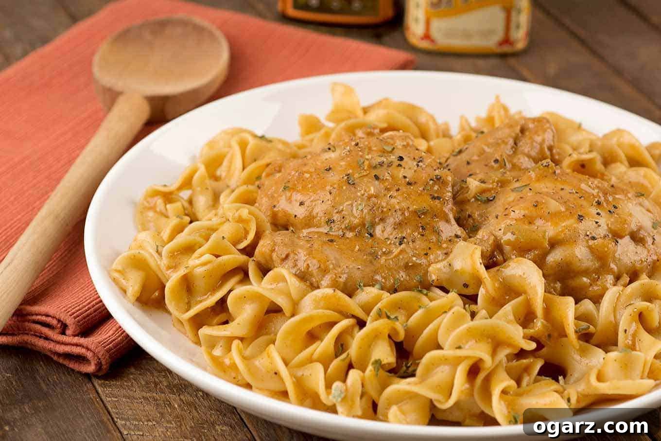 Creamy Instant Pot Chicken Paprikas 3 Creamy chicken paprikash featuring tender chicken thighs in a smooth, paprika-infused sauce, nestled on a bed of egg noodles.