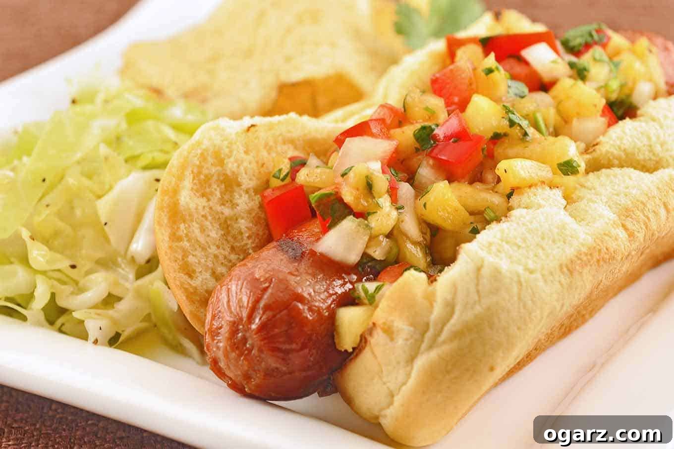 Tropical Kick Dogs 2 Grilled Hot Dogs with Pineapple-Pepper Relish, generously topped with fresh pineapple, red bell pepper, sweet onion, and cilantro.