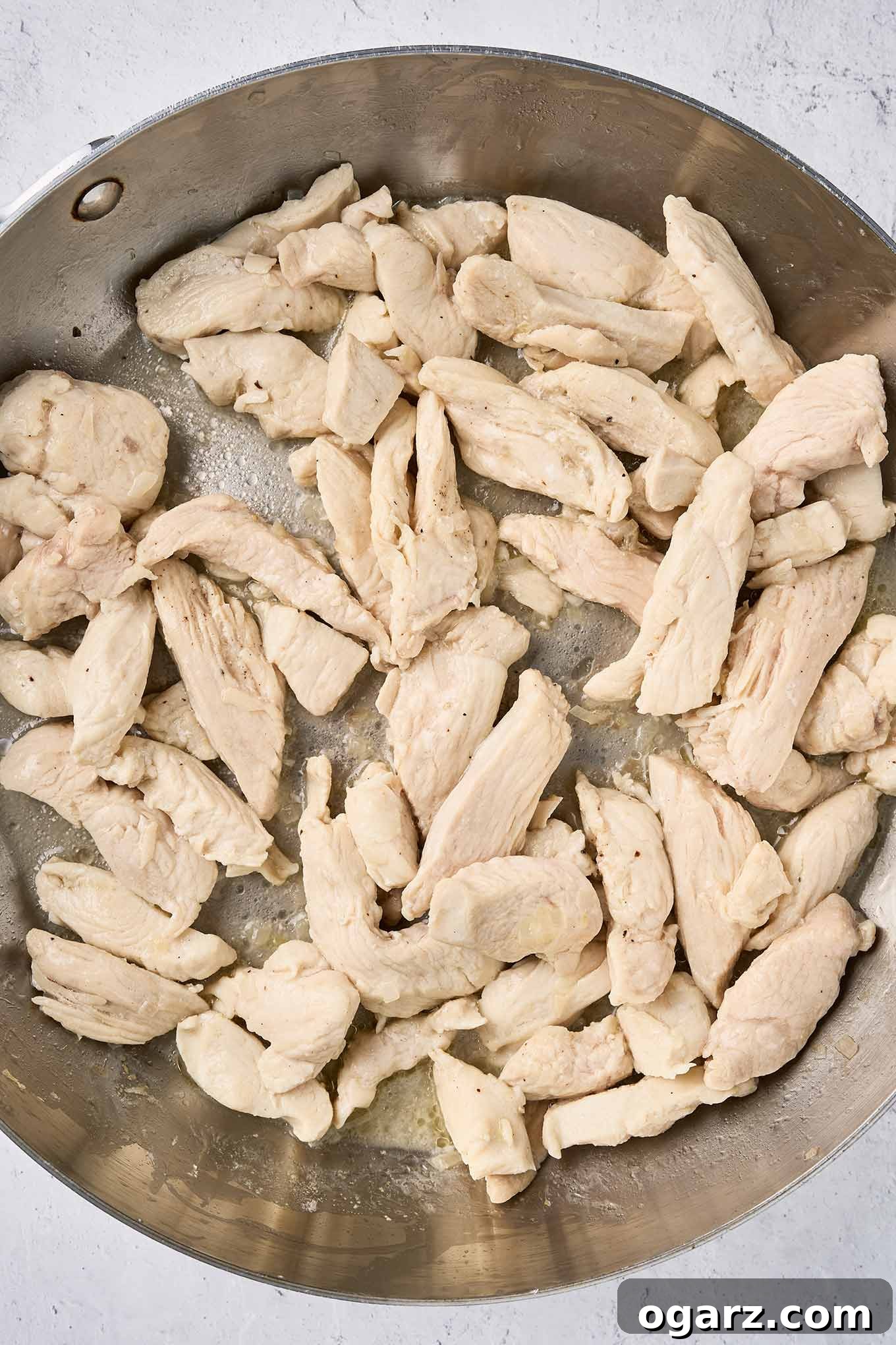 Nutty Brown Butter Chicken Pasta 5 Step one making brown butter pasta with chicken - strips of boneless, skinless chicken breasts lightly sautéed in butter with minced shallots, achieving a golden hue.