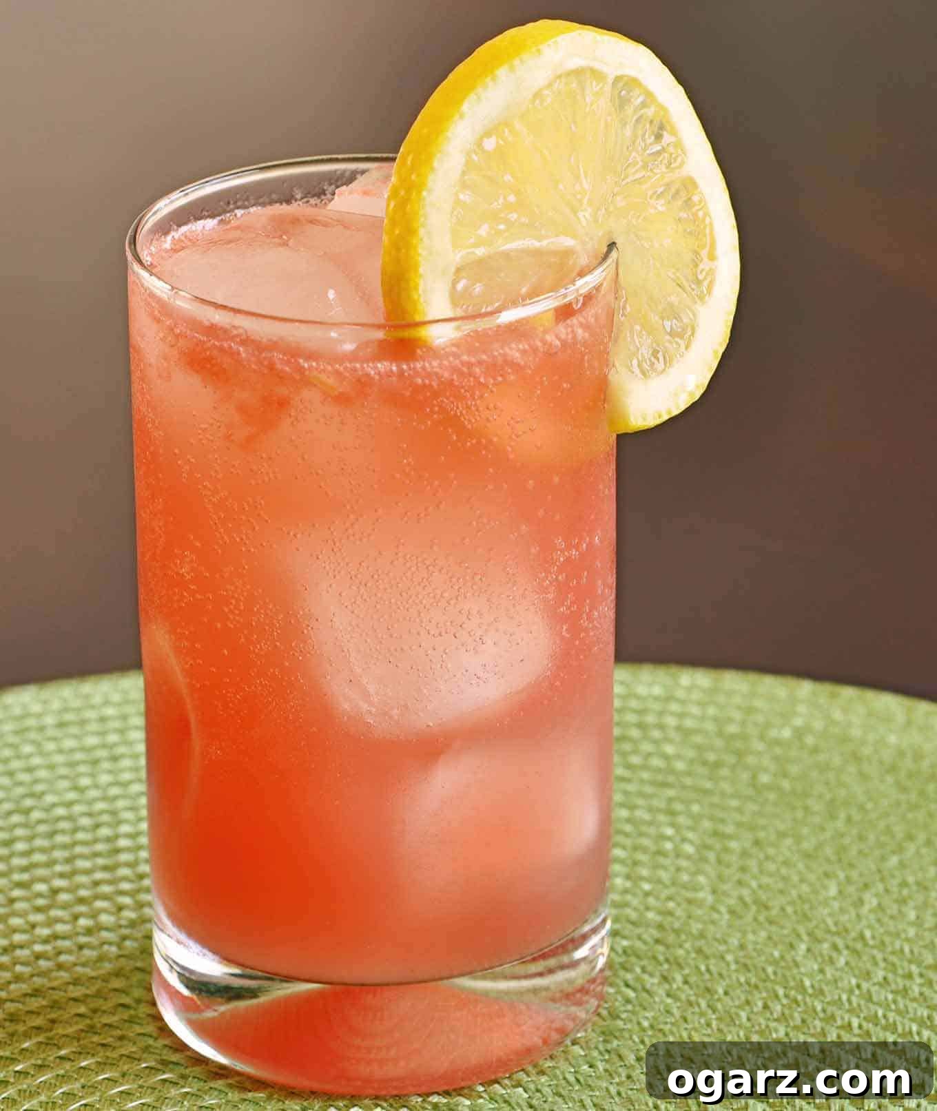 Limoncello Watermelon Sparkler 2 Chilled Watermelon-Limoncello Collins cocktail with ice, garnished with a lemon slice on the rim of the glass.