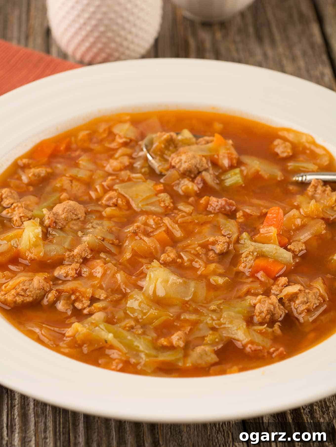 Quick & Cozy Cabbage Soup 4 A serving bowl of pressure cooker (Instant Pot) cabbage soup with crumbled ground turkey, smoked sausage, and cabbage in a tomato-based broth, ready to serve.
