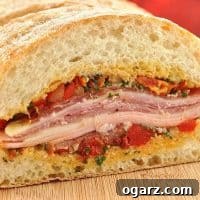 Mediterranean Muffuletta sandwich with basil vinaigrette and cold cuts