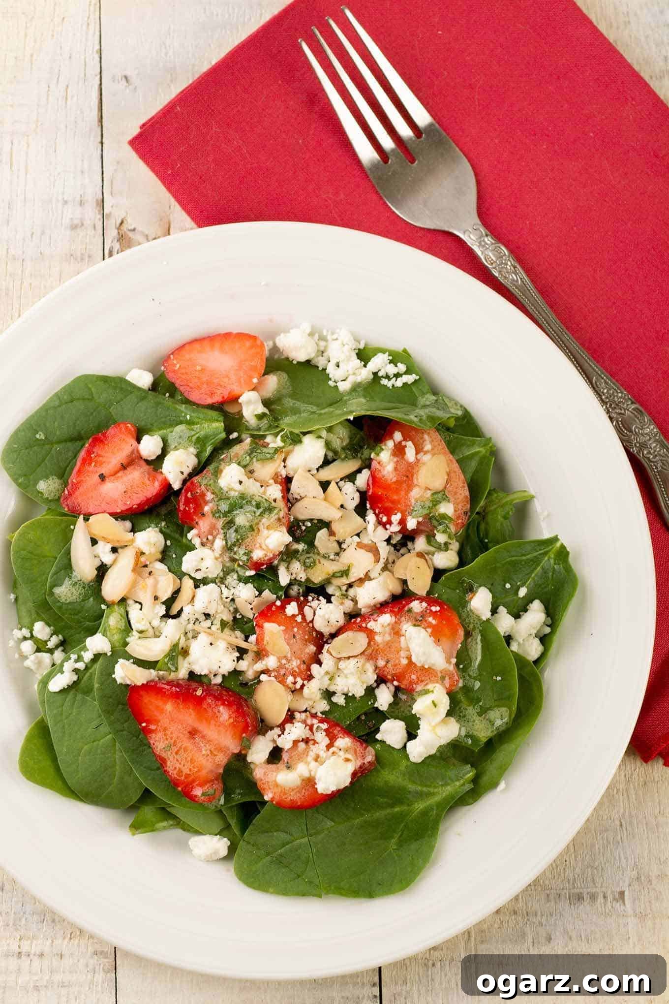 Vibrant Spinach Strawberry Salad 2 Vibrant spinach and strawberry salad with goat cheese, toasted almonds, and creamy basil vinaigrette.