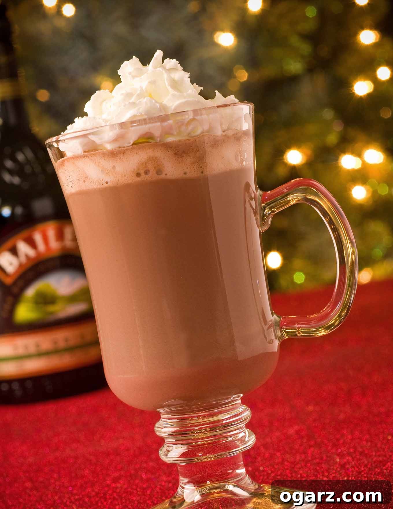 Celtic Cocoa Comfort 2 A steaming clear Irish coffee mug of hot chocolate, generously topped with fluffy whipped cream and a sprinkle of cocoa powder, with warm, blurred Christmas lights twinkling in the background, creating a cozy and inviting scene.