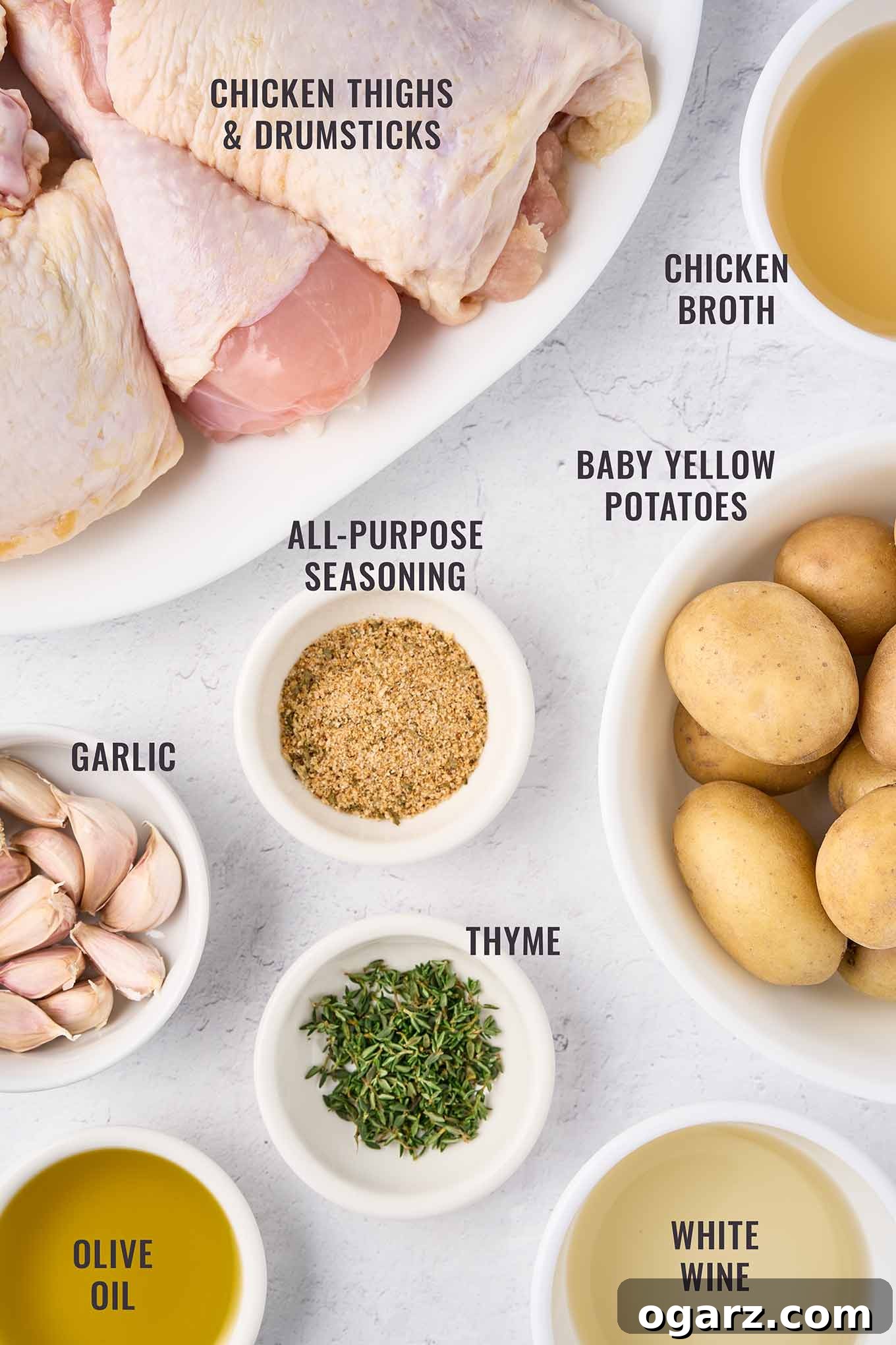 Rustic Slow-Braised Chicken and Potatoes 3 Fresh ingredients laid out for braised chicken legs with potatoes: bone-in chicken thighs, garlic cloves, fresh thyme sprigs, baby potatoes, chicken broth, olive oil, dry white wine, and seasoning blend.