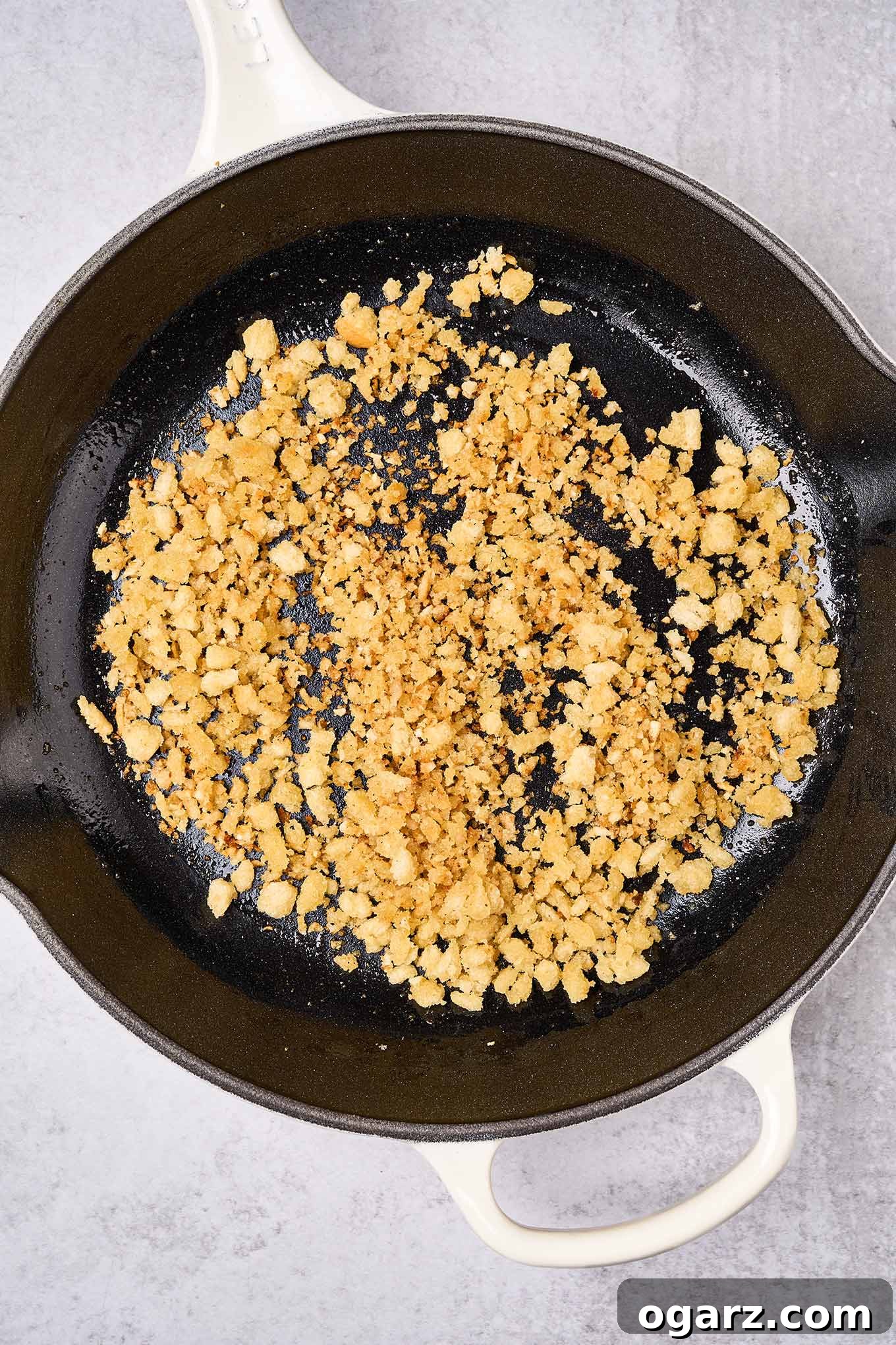 Lemon-Garlic Sardine Pasta with Golden Pangrattato 4 A preparation photo of toasted garlic breadcrumbs in a cast iron pan, illustrating the optimal golden brown color for the finished dish.
