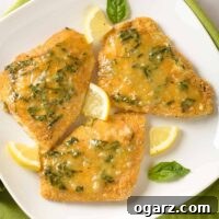 Crispy Oven Fish with Fresh Lemon-Basil Butter 4 Three pieces of breaded, oven-fried fish fillets topped with lemon butter infused with fresh basil and garnished with basil leaves and lemon wedges.