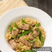 Pork Ramen Skillet Sensation 4 A shallow bowl of ramen noodles tossed with stir-fried pork, sugar snap peas, and scallions in soy-ginger sauce.