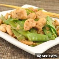 Stir-Fried Chicken with Snow Peas and Ginger in a pan