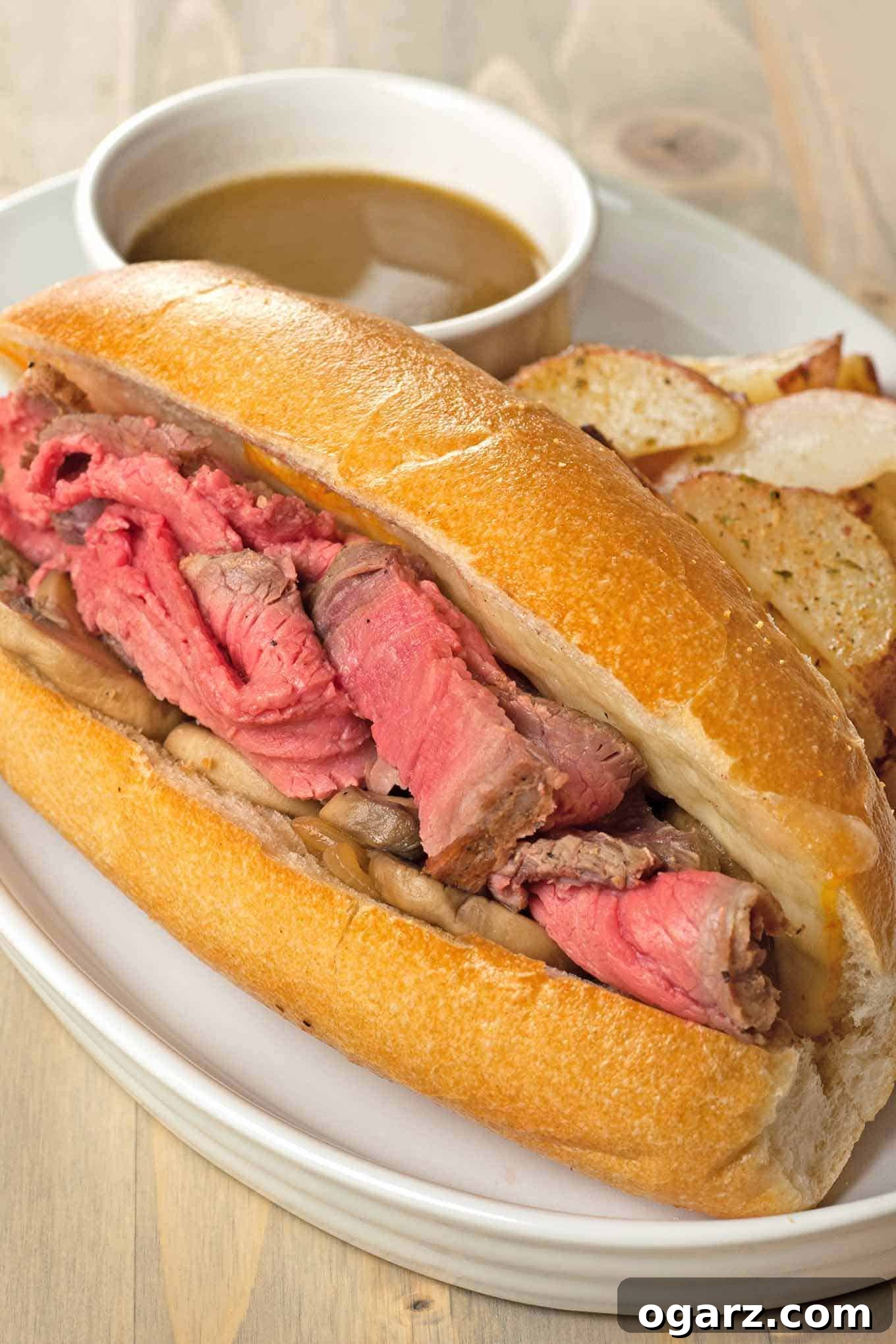 Effortless French Dip Delight 2 Delicious French Dip Sandwiches with melted Muenster cheese, caramelized onions, and a side of savory au jus for dipping.