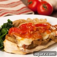 Circular image of Chicken Sorrentino - chicken breast topped with eggplant, melted cheese, and tomato sauce.