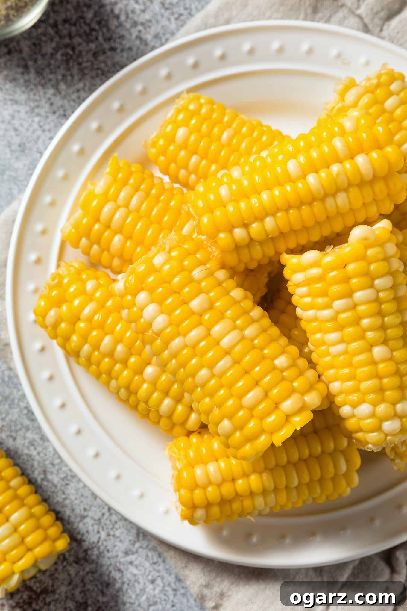 Boiled ears of corn, cut in half and piled onto a serving platter.