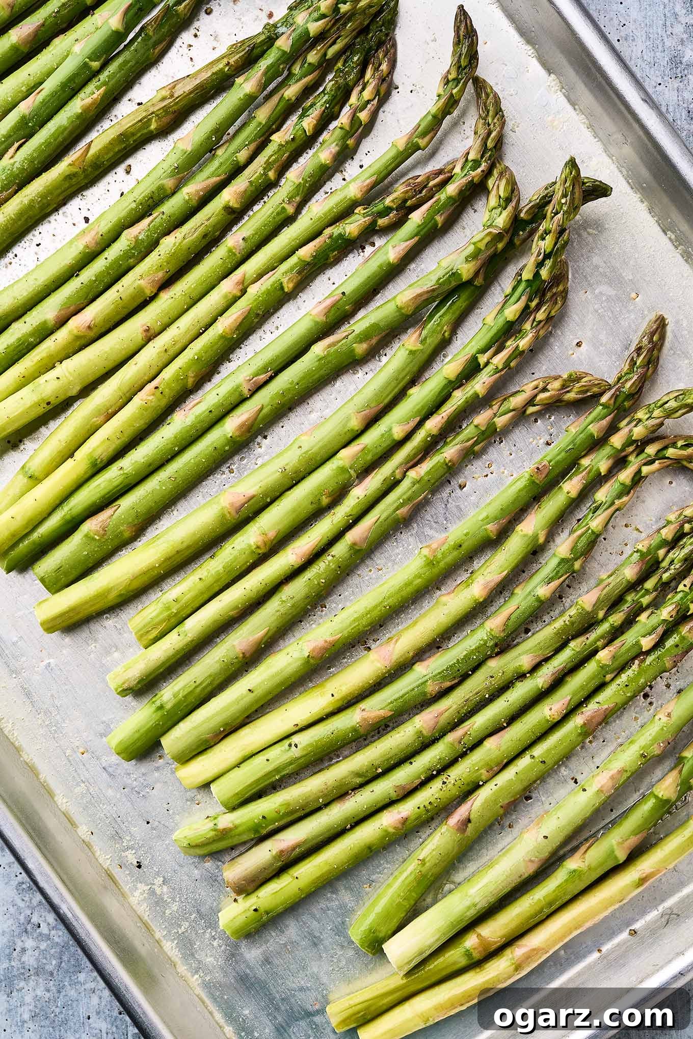 Zesty Roasted Asparagus 4 Fresh asparagus spears coated in melted butter and seasoned with salt and pepper, ready to be roasted.