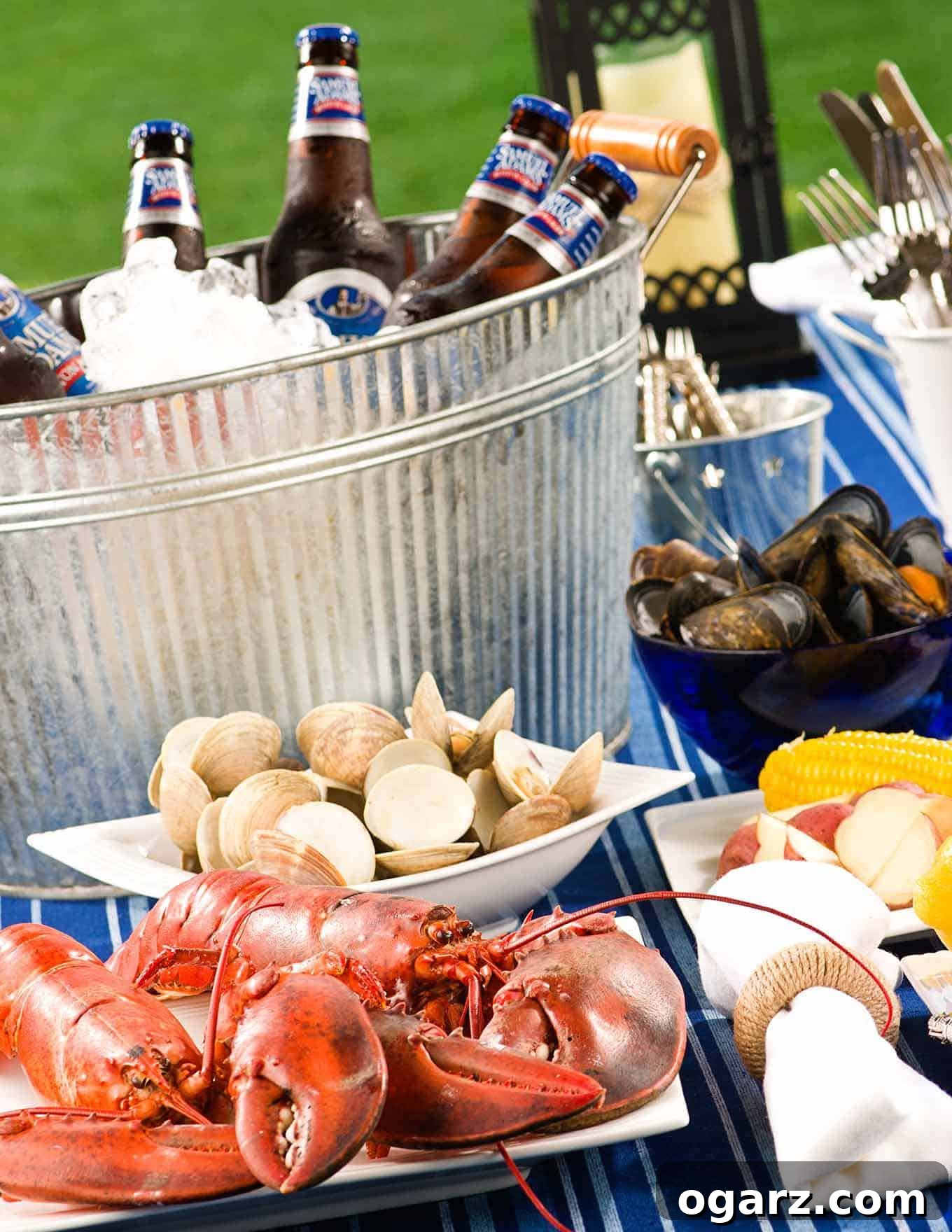 Home Clambake Delight 6 A vibrant table spread for a clambake, brimming with freshly cooked lobsters, steamed clams, mussels, tender potatoes, sweet corn, essential utensils, and a bucket of ice chilling cold bottles of beer, ready for a festive seafood meal.