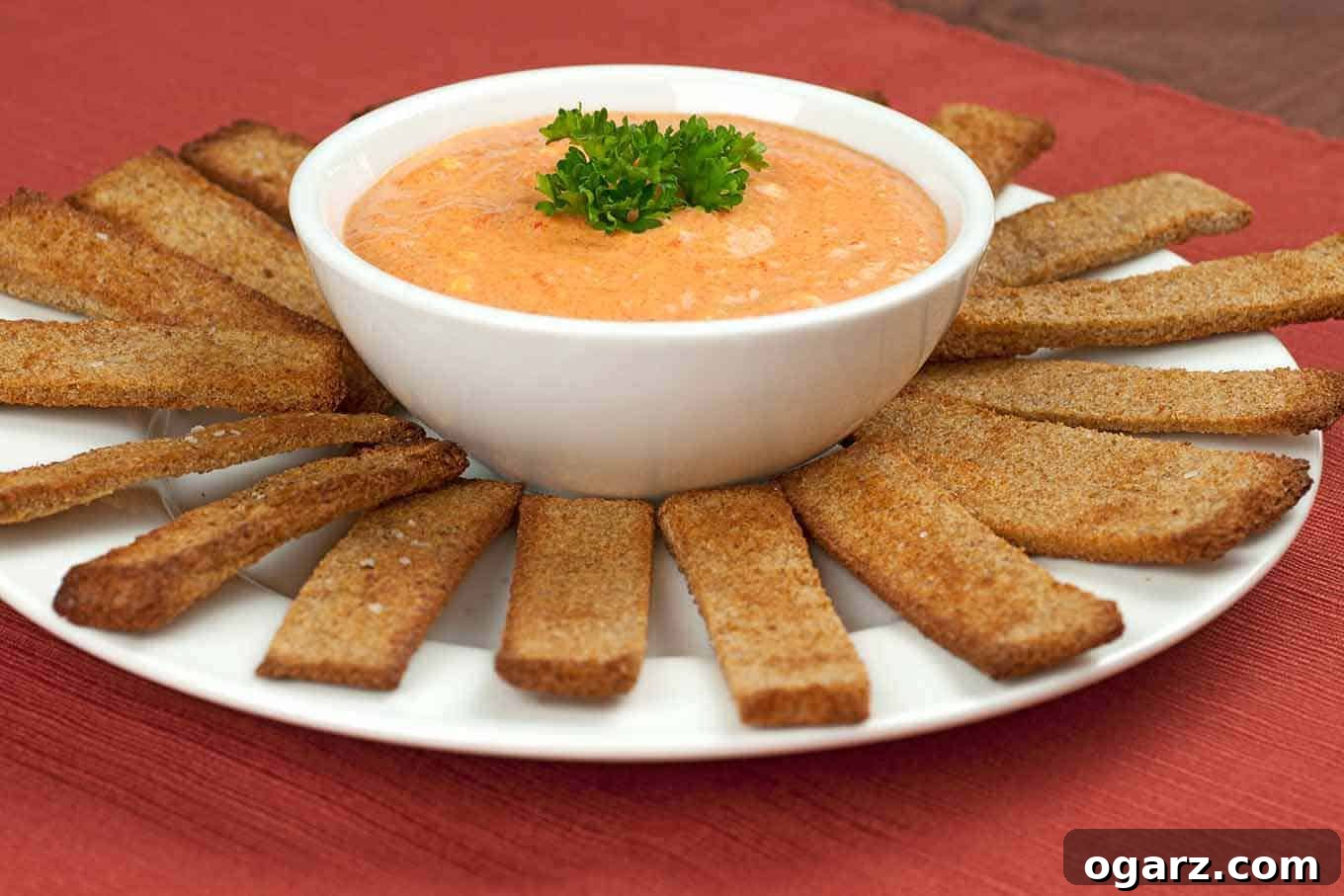 Homemade Roasted Red Pepper Dip - The Perfect Appetizer Creamy Roasted Red Pepper Dip served with whole wheat garlic toasts and fresh vegetables, a vibrant and healthy appetizer.