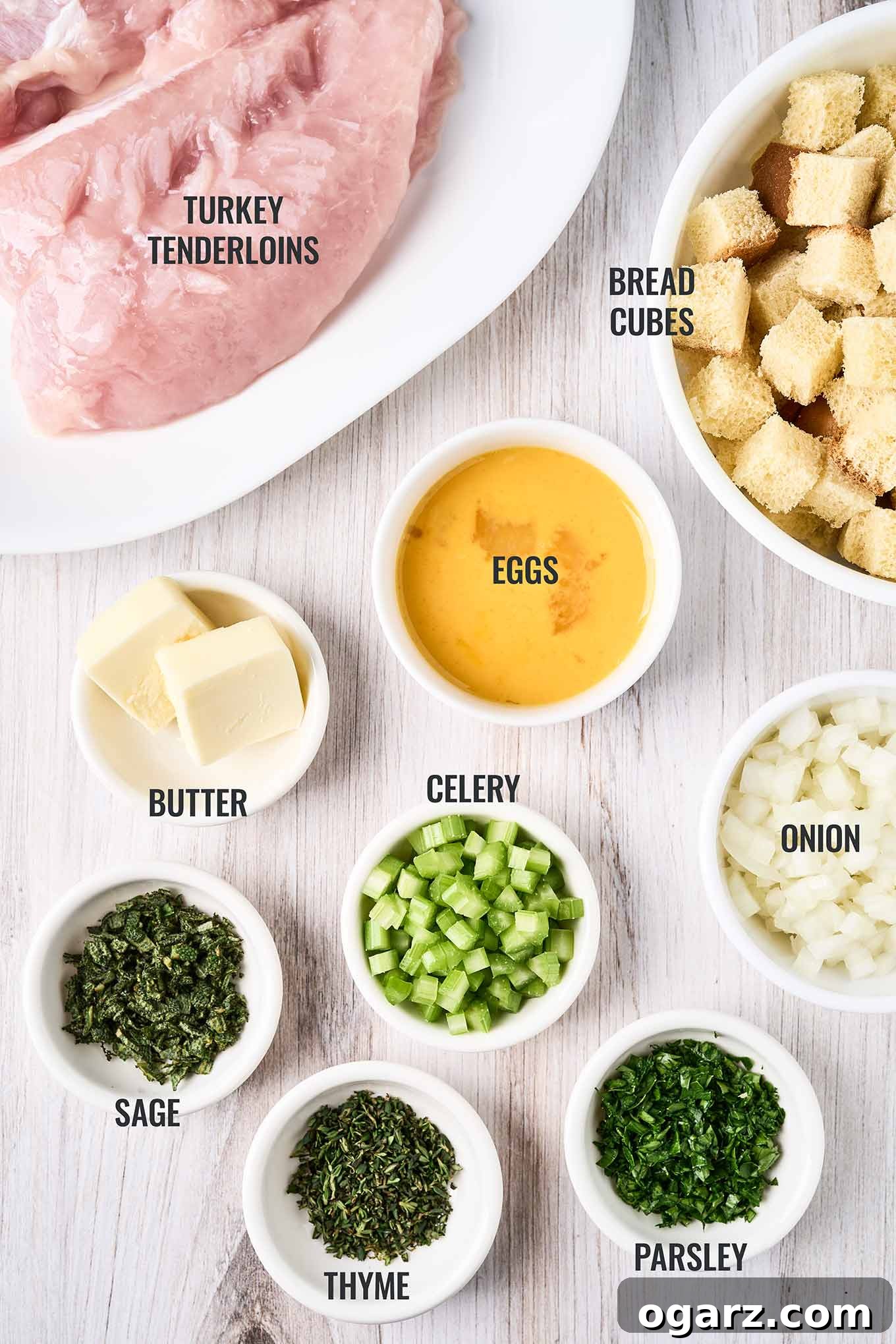 Succulent Baked Turkey Tenderloins with Savory Stuffing 3 A labeled, overhead view of the ingredients for baked, stuffed turkey tenderloins, including bread, eggs, butter, onion, celery, sage, thyme, and parsley.