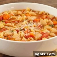 Close-up of a serving of Pasta e Fagioli, showcasing the texture and rich ingredients.