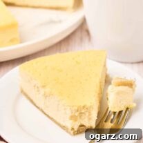 A slice of Italian ricotta pie on a plate with a bite on a fork, the remaining pie and a cup of coffee in the background.