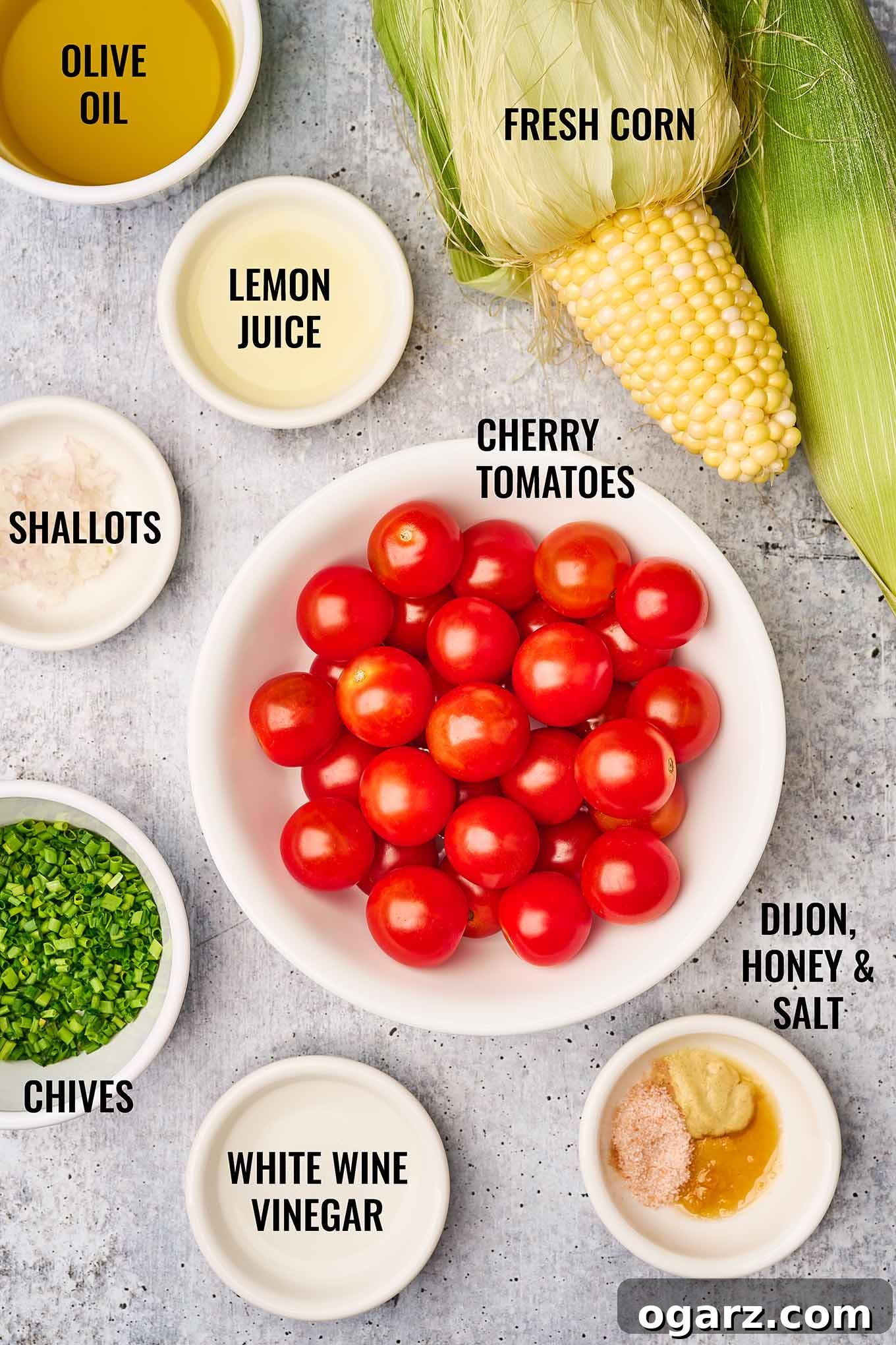 Sunshine Corn and Tomato Medley 3 Labeled photo of corn and tomato salad ingredients including cherry tomatoes, fresh corn on the cob, lemon juice, shallots, and chives.