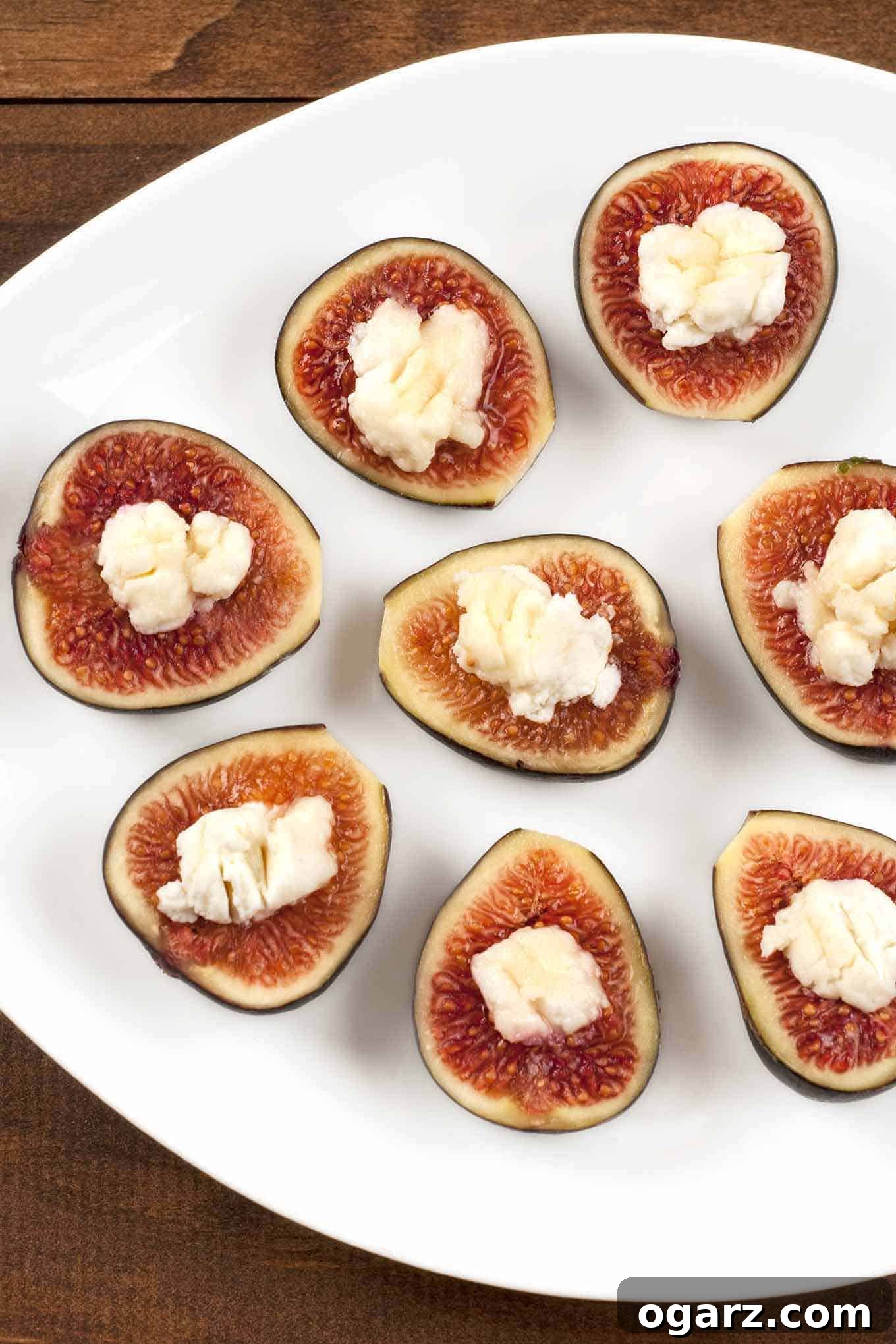 Fresh figs filled with creamy goat cheese and drizzled with honey, ready to be served as an elegant appetizer.