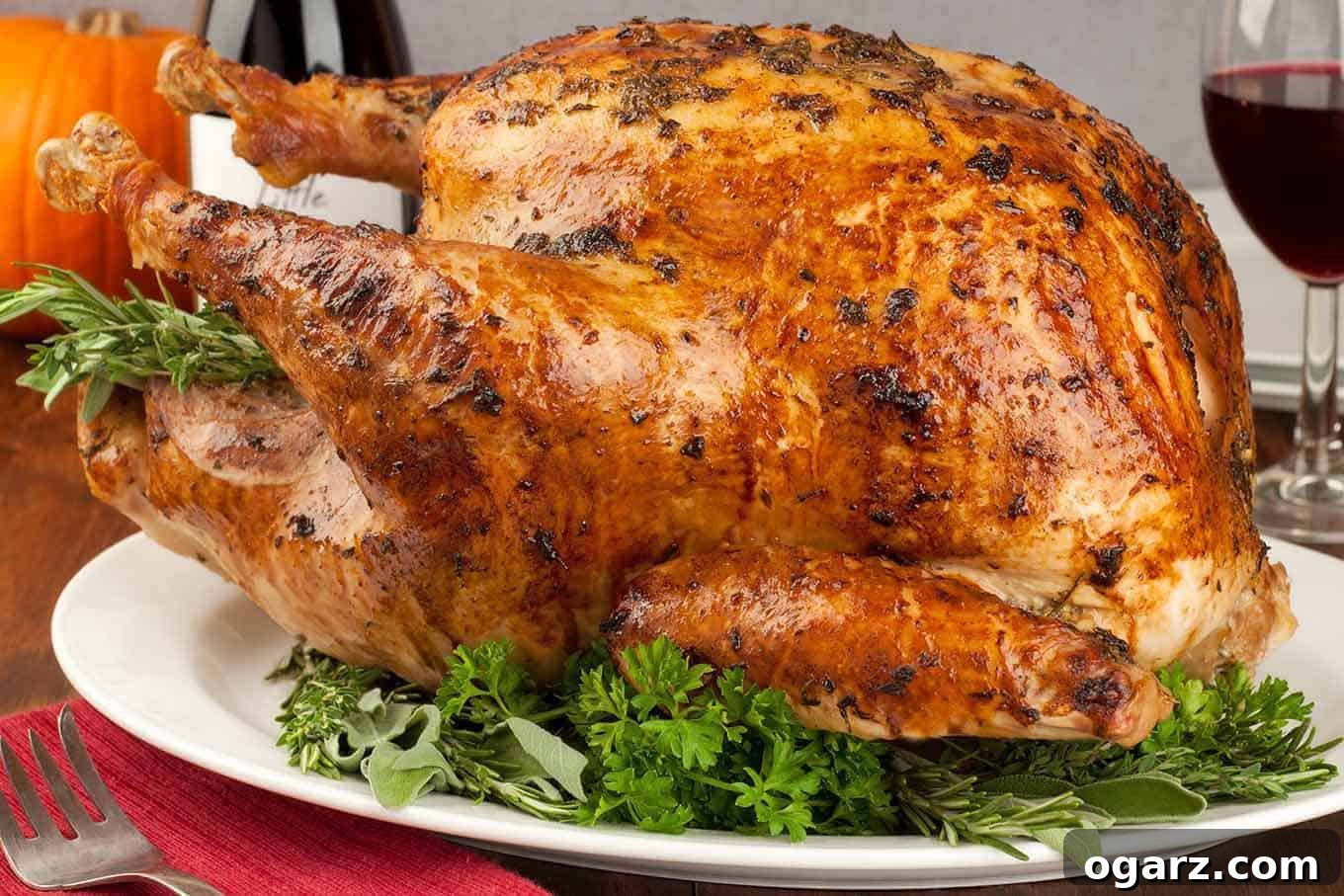 Golden Herb Turkey with a Mayonnaise Glaze 4 A whole, mayonnaise coated turkey on a platter, waiting to be carved, a bottle and glass of wine in the background.