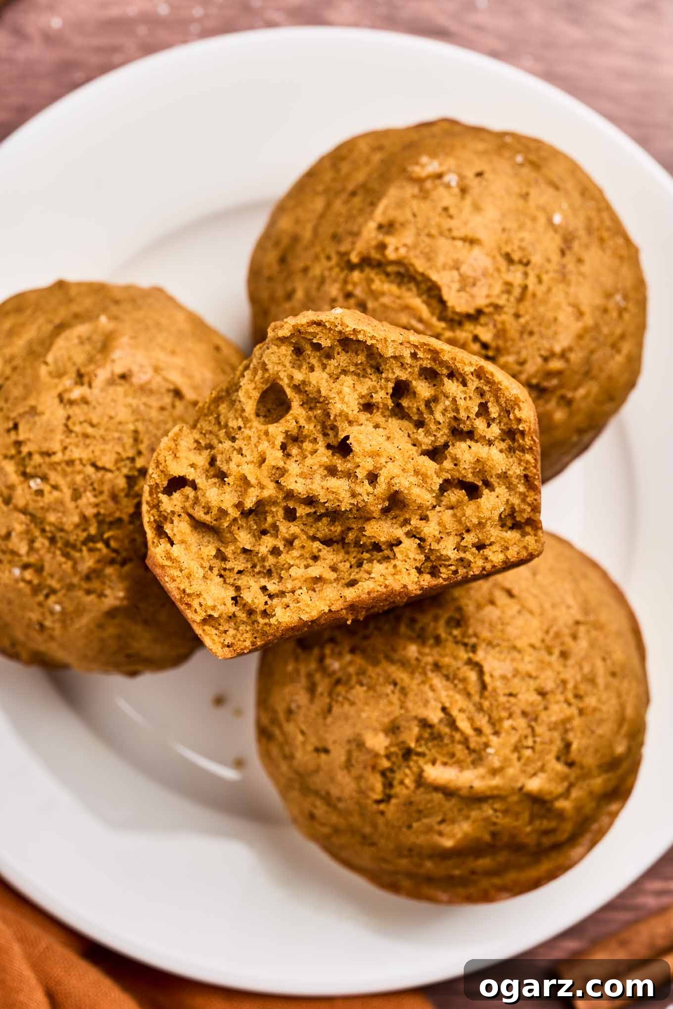 A plate of autumn-inspired pumpkin spice muffins, exquisitely made with fragrant spices and rich pumpkin puree, representing the ideal treat for fall baking and festive occasions.