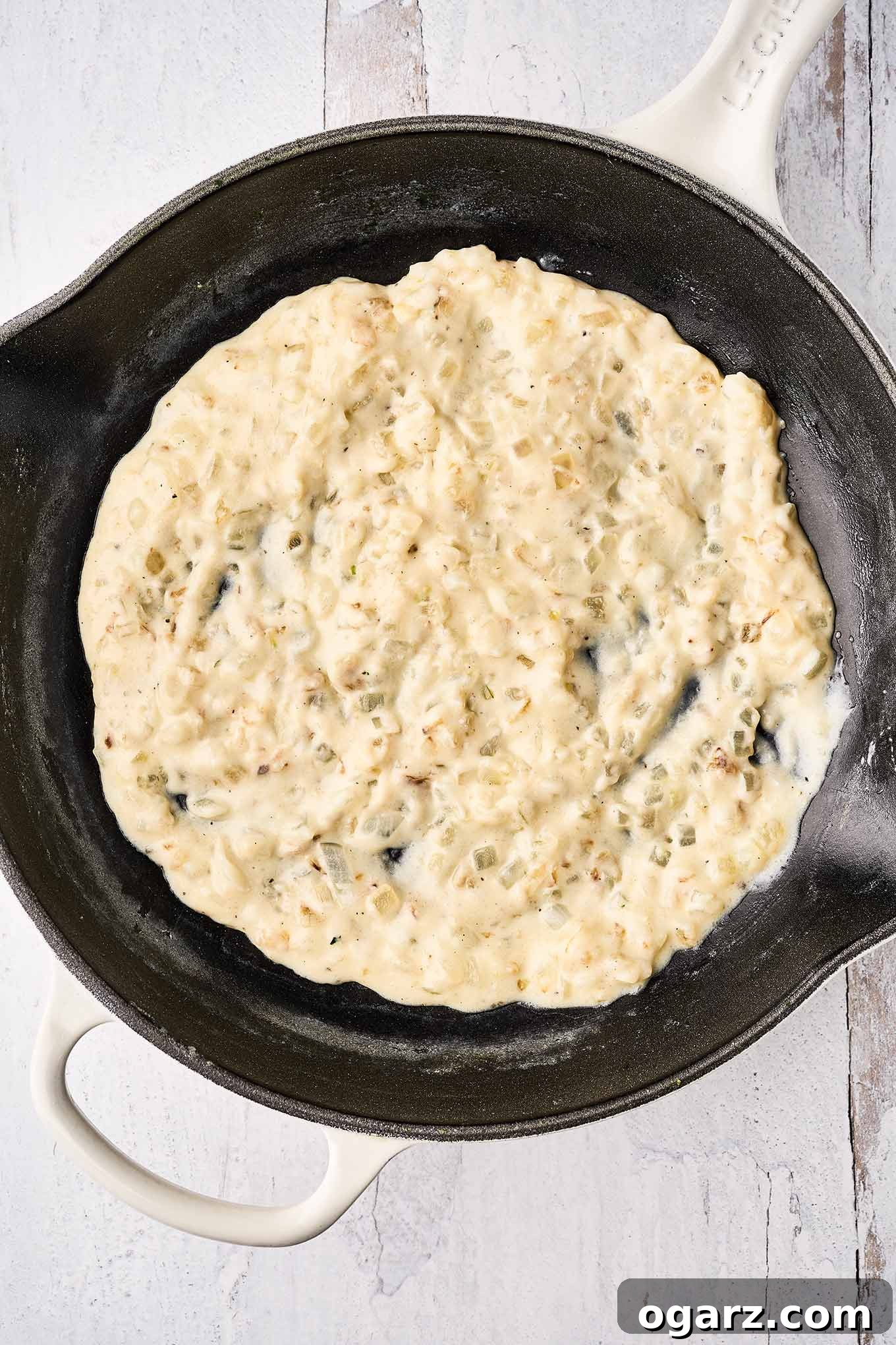 Velvety Creamed Spinach 5 A cast iron pan filled with onions sautéed in butter, combined with flour and milk to make a thick roux for creamed spinach.