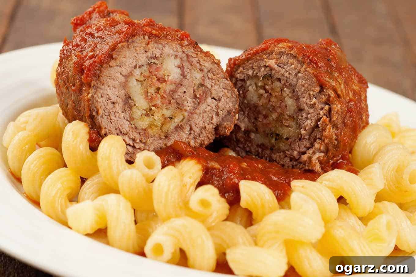 Melt-In-Your-Mouth Slow Cooker Beef Braciole 3 Slow cooker Italian beef braciole, sliced to show the filling of salami, breadcrumbs, and cheese.