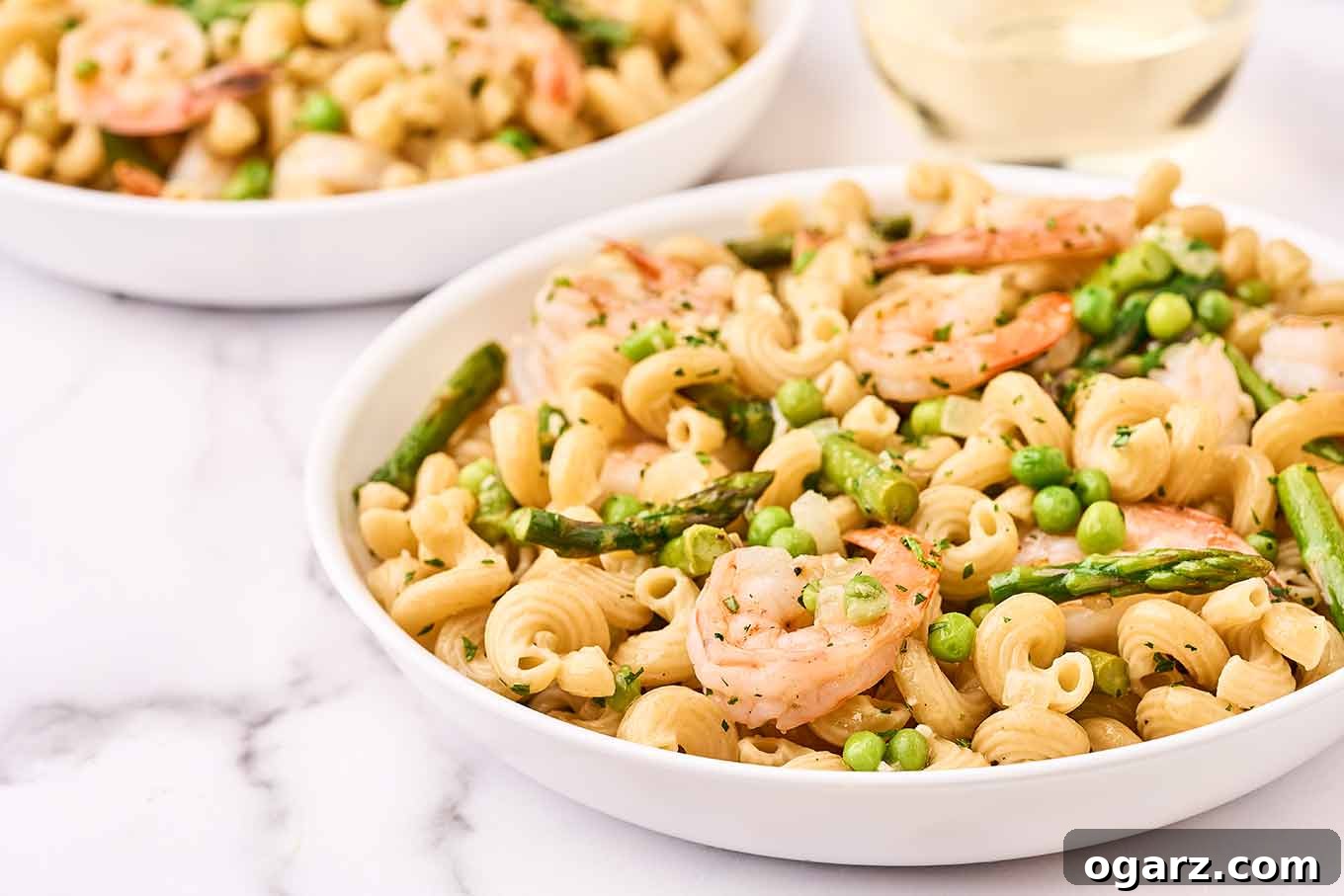 Shrimp pasta primavera, plated in pasta bowls, ready to be served.