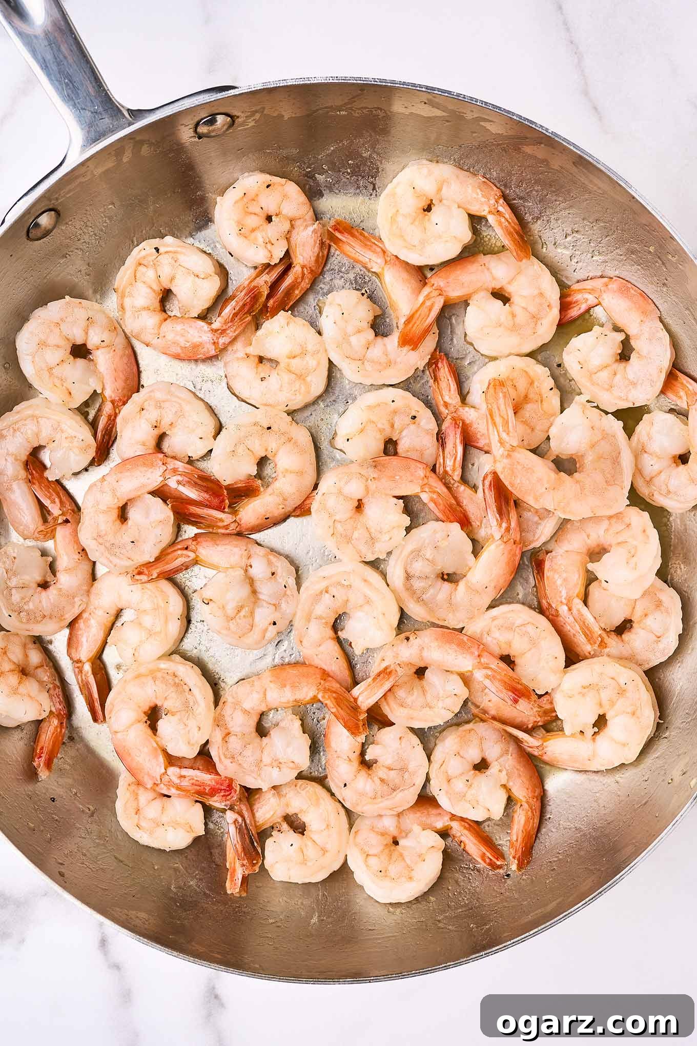 Perfectly sautéed shrimp in a frying pan, ready to be combined with other ingredients to make shrimp pasta primavera.