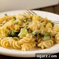 Cheesy Garlic Parmesan Pasta Bake 5 A close-up photo of rotini pasta tossed with sautéed escarole and a creamy, garlic and Parmesan cheese sauce.
