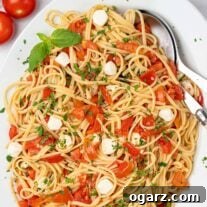 Vibrant Caprese Pasta 6 An oval serving platter of caprese pasta; linguine tossed with chopped fresh tomatoes, fresh mozzarella, basil, and parsley.