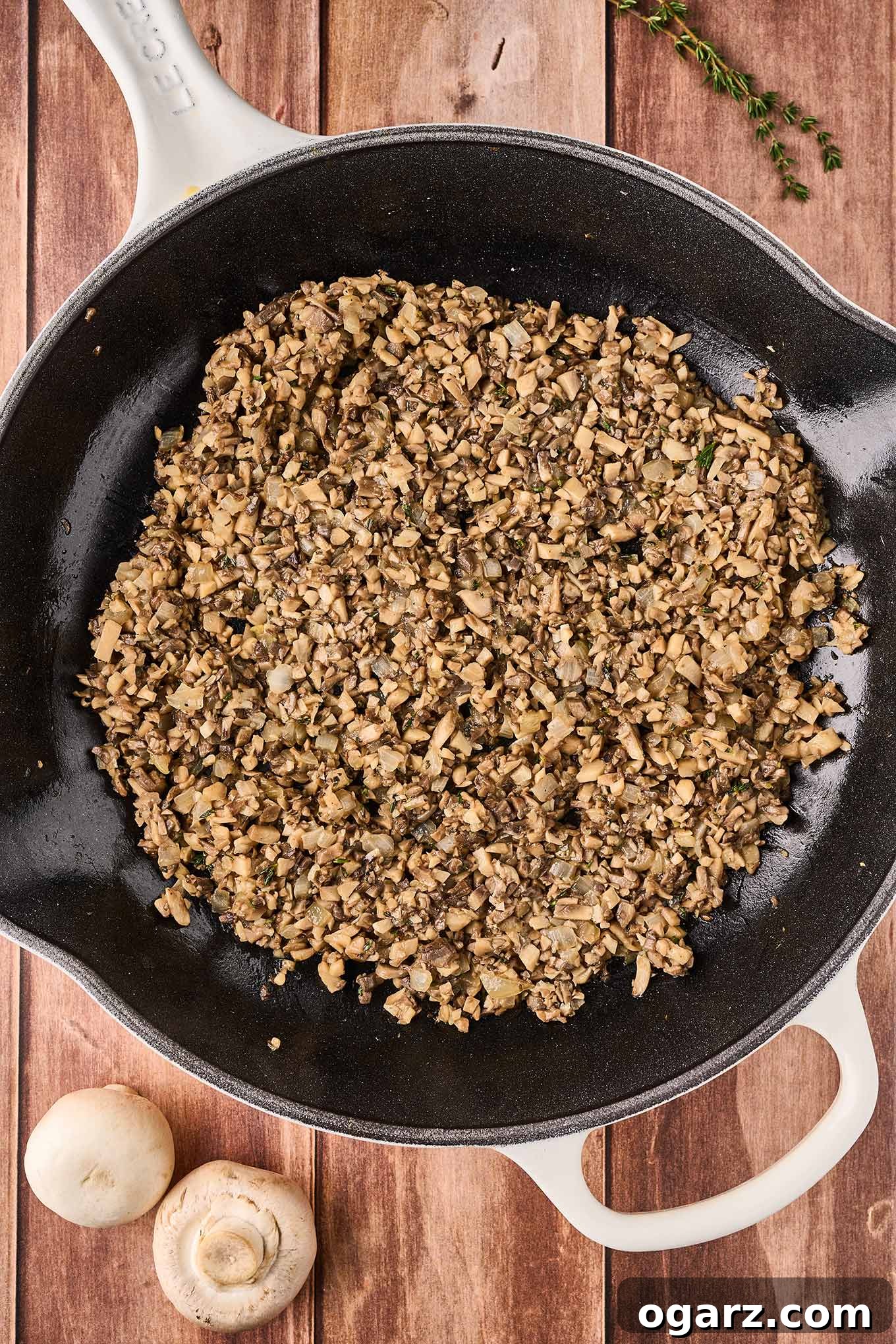 Umami Mushroom Puffs 5 A cast iron pan filled with sautéed chopped mushrooms to squares of puff pastry to make mushroom puff appetizers.